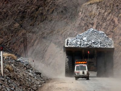 A safety vehicle follows a mining truck loaded with excavated kimberlite rock out of Jwaneng mine, operated by the Debswana Diamond Co., a joint venture between De Beers and Botswana's government, in Jwaneng, Botswana, on Wednesday, Oct. 24, 2012. XXX SECOND SENTENCE HERE XXX. Photographer: Chris Ratcliffe/Bloomberg